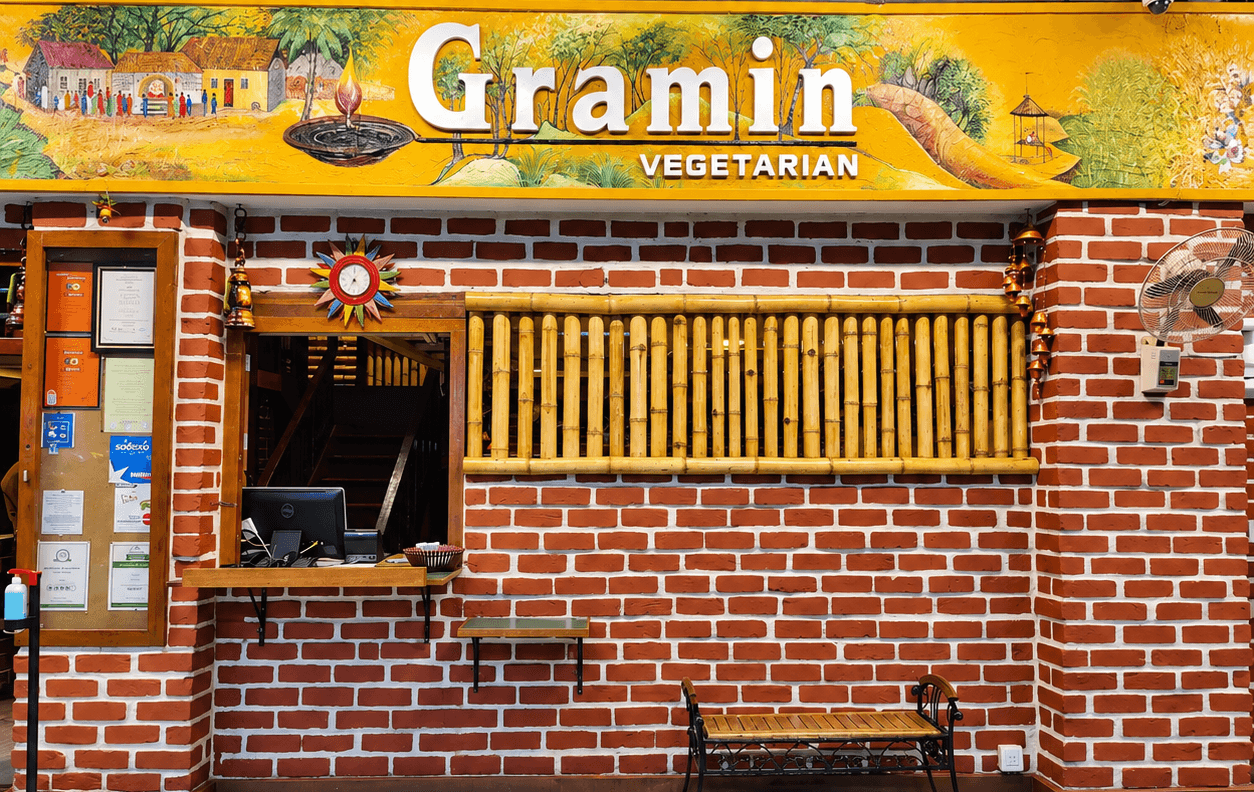 The Gramin Vegetarian shopfront with a spread of thalis, breads and chaat